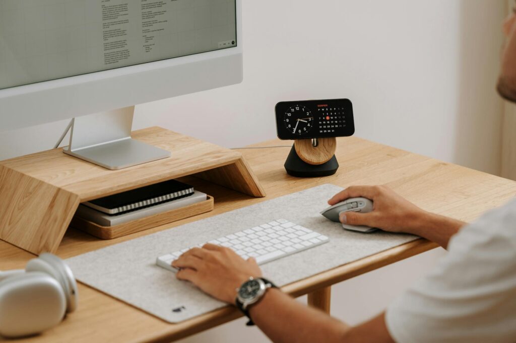 a man is sitting at a desk with a computer monitor